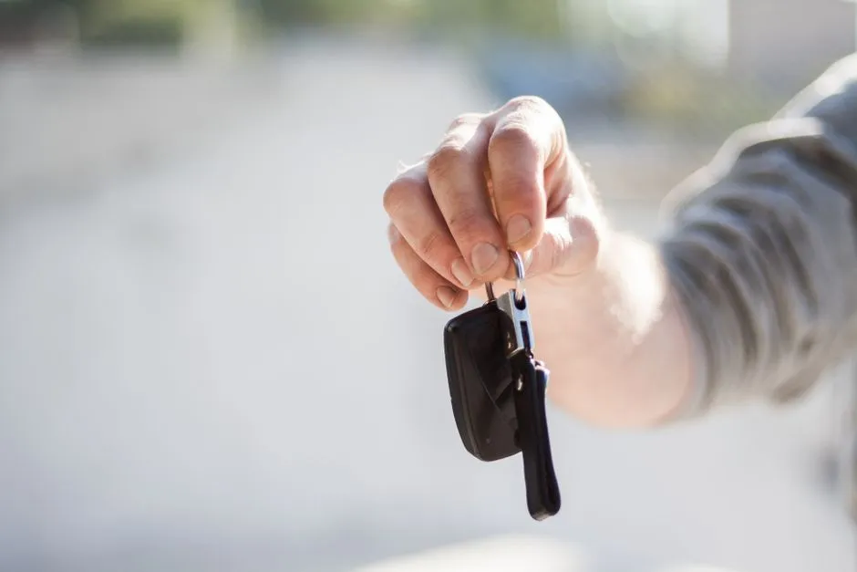 Handing over a car key after a driving test